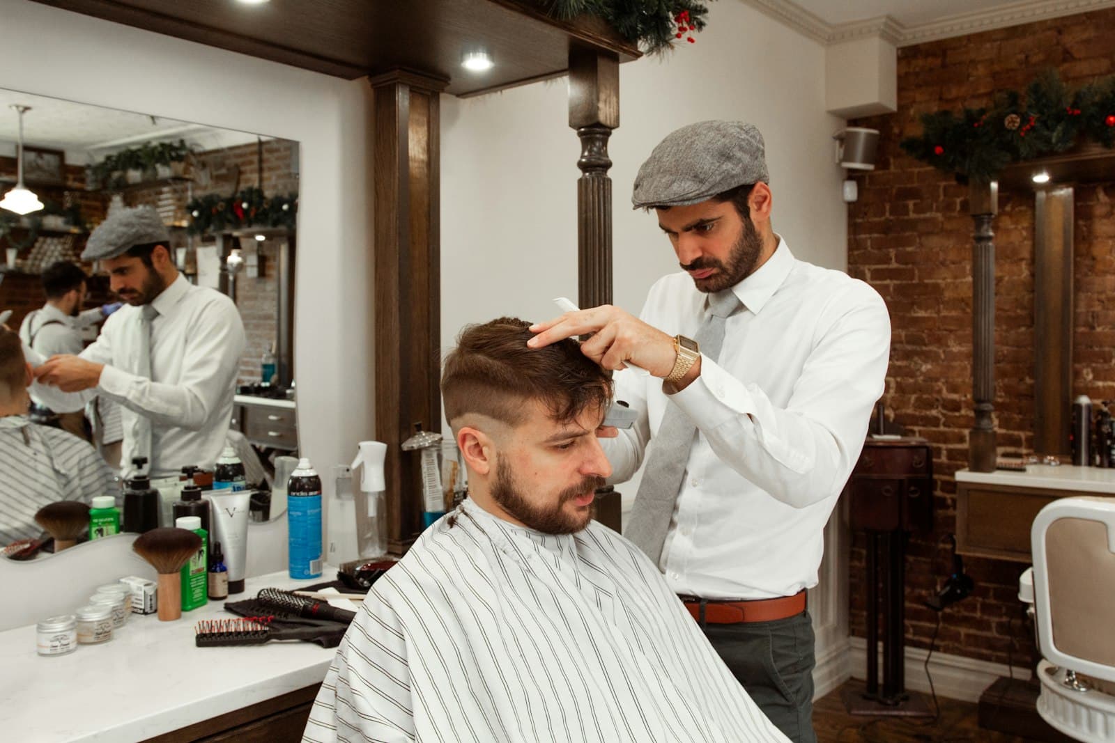 Two barbers working in a busy shop